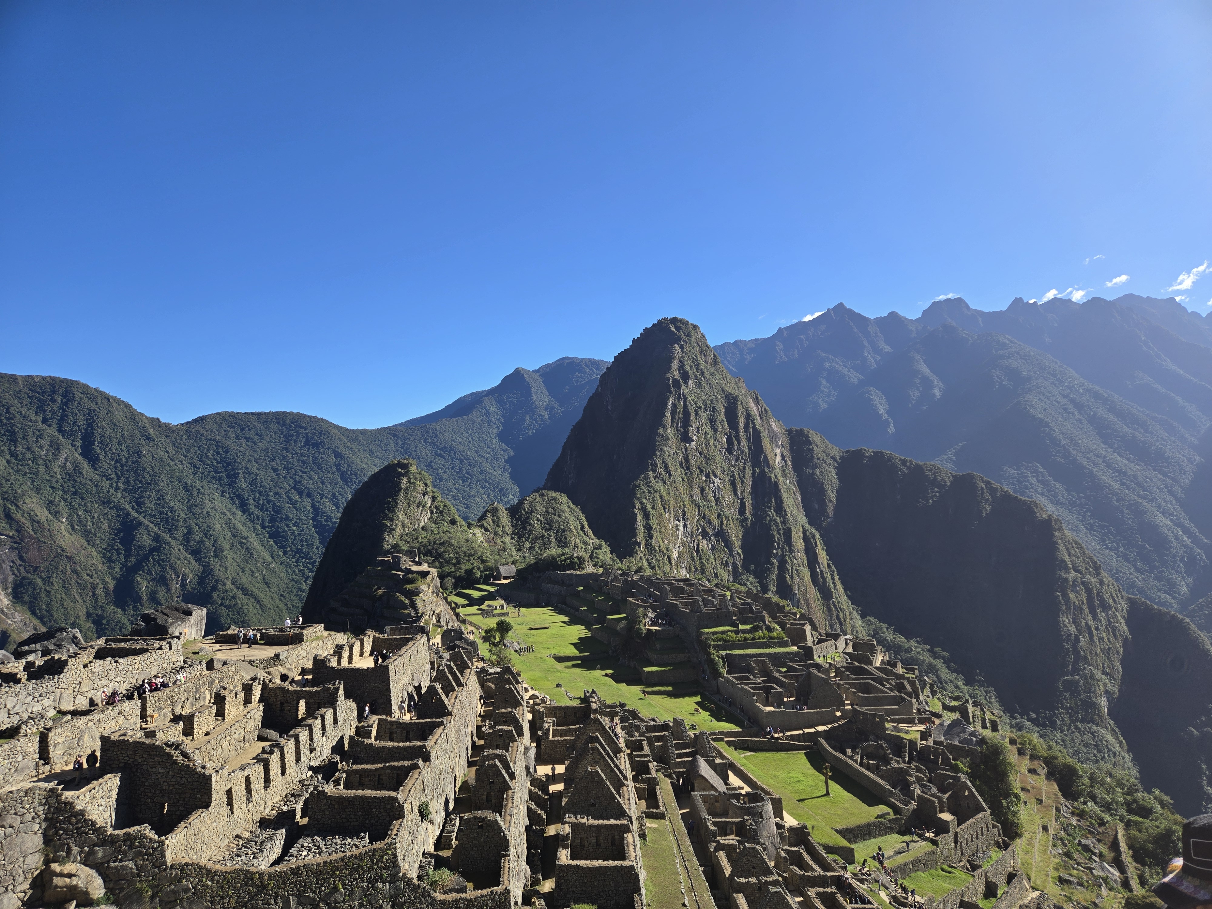Machu Picchu viewed from above with green mountains in the background