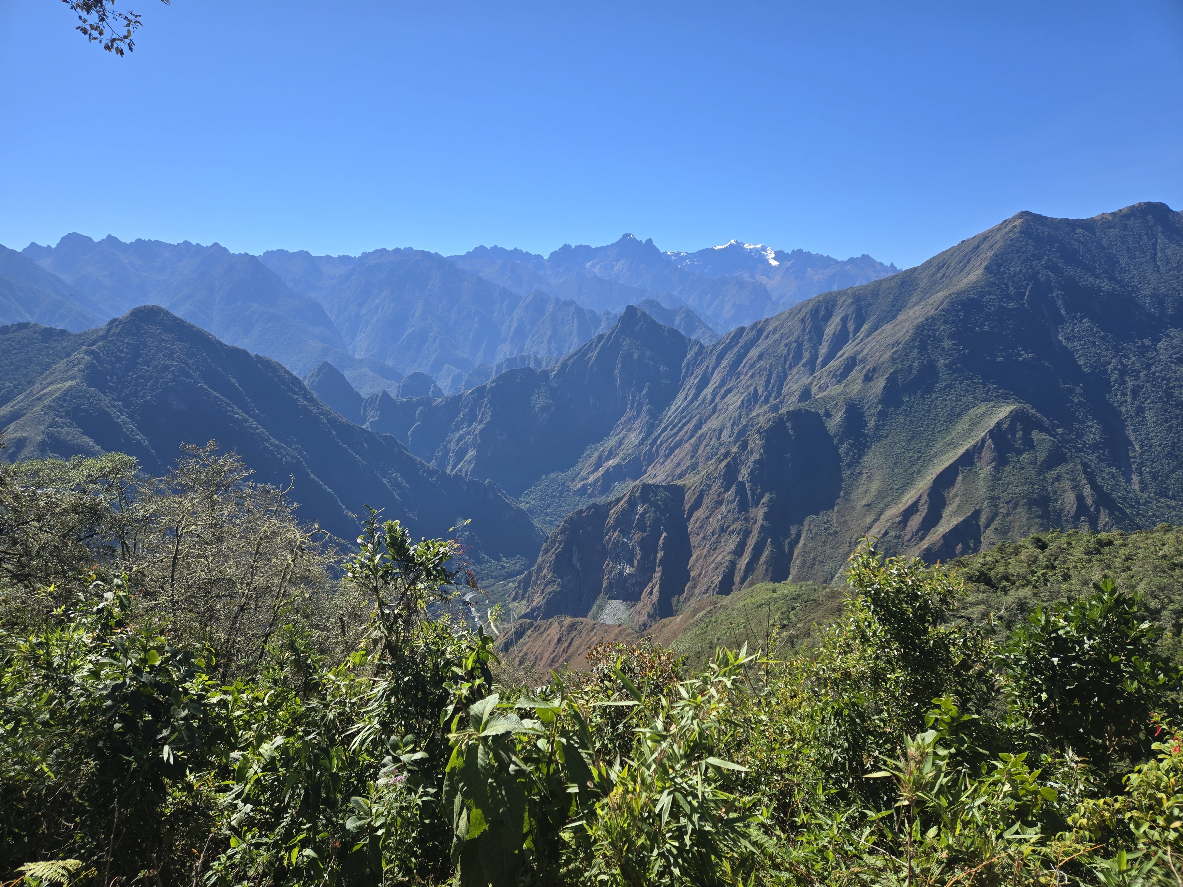 Machu Picchu visible in the distance between the mountains