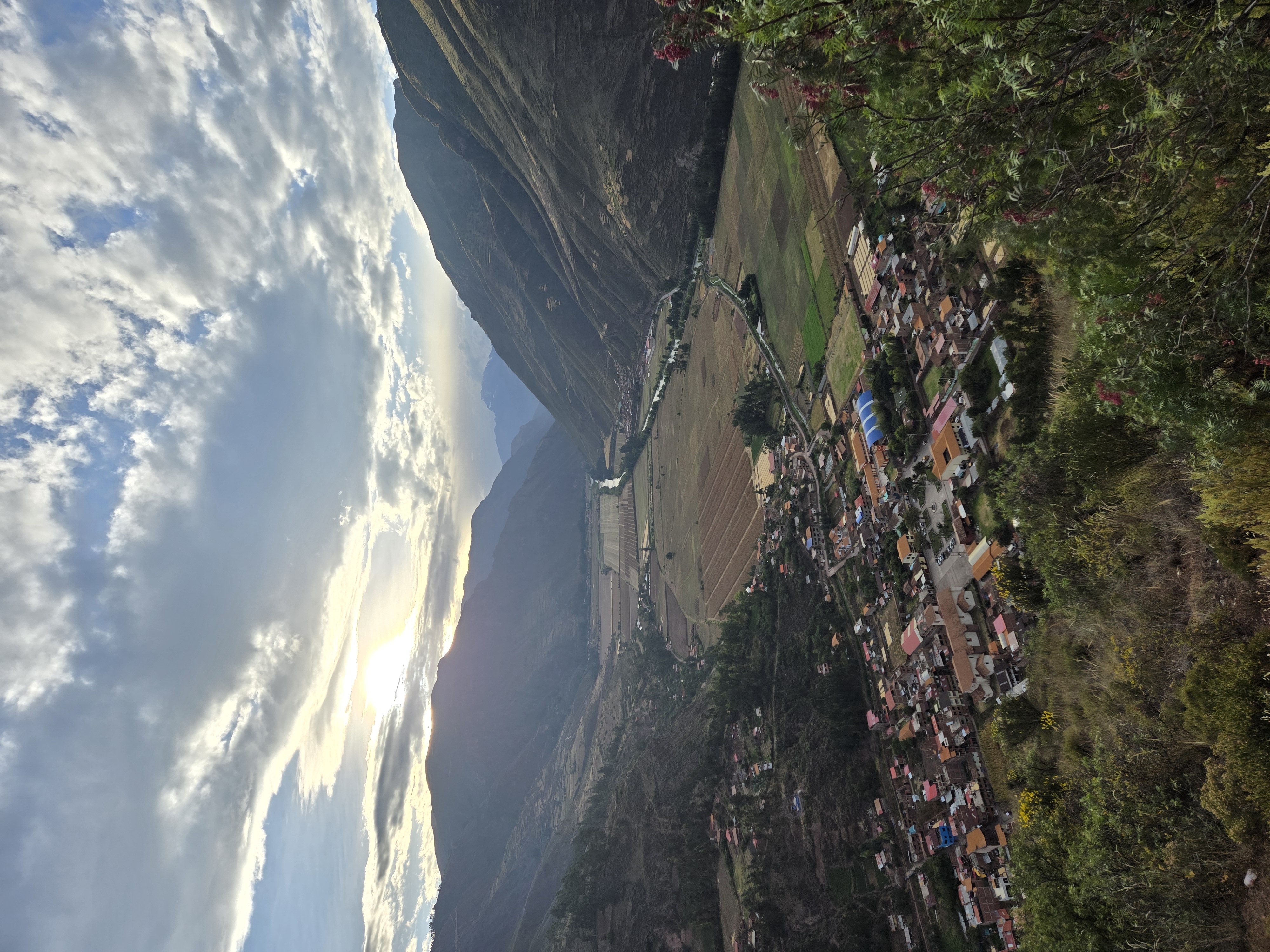 Green agricultural land and mountains in Peru's Sacred Valley