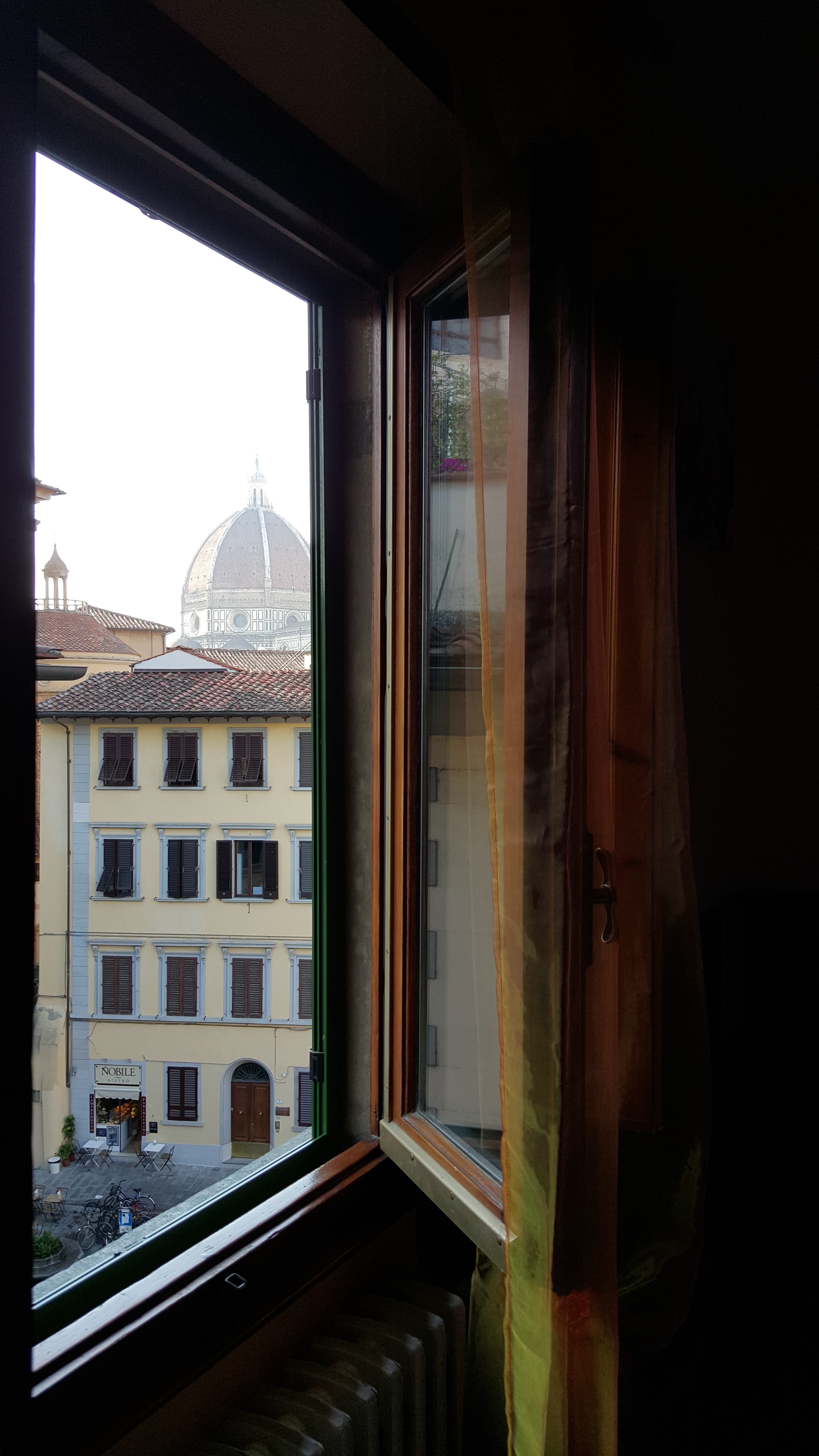 Looking out a hotel window in Florence
