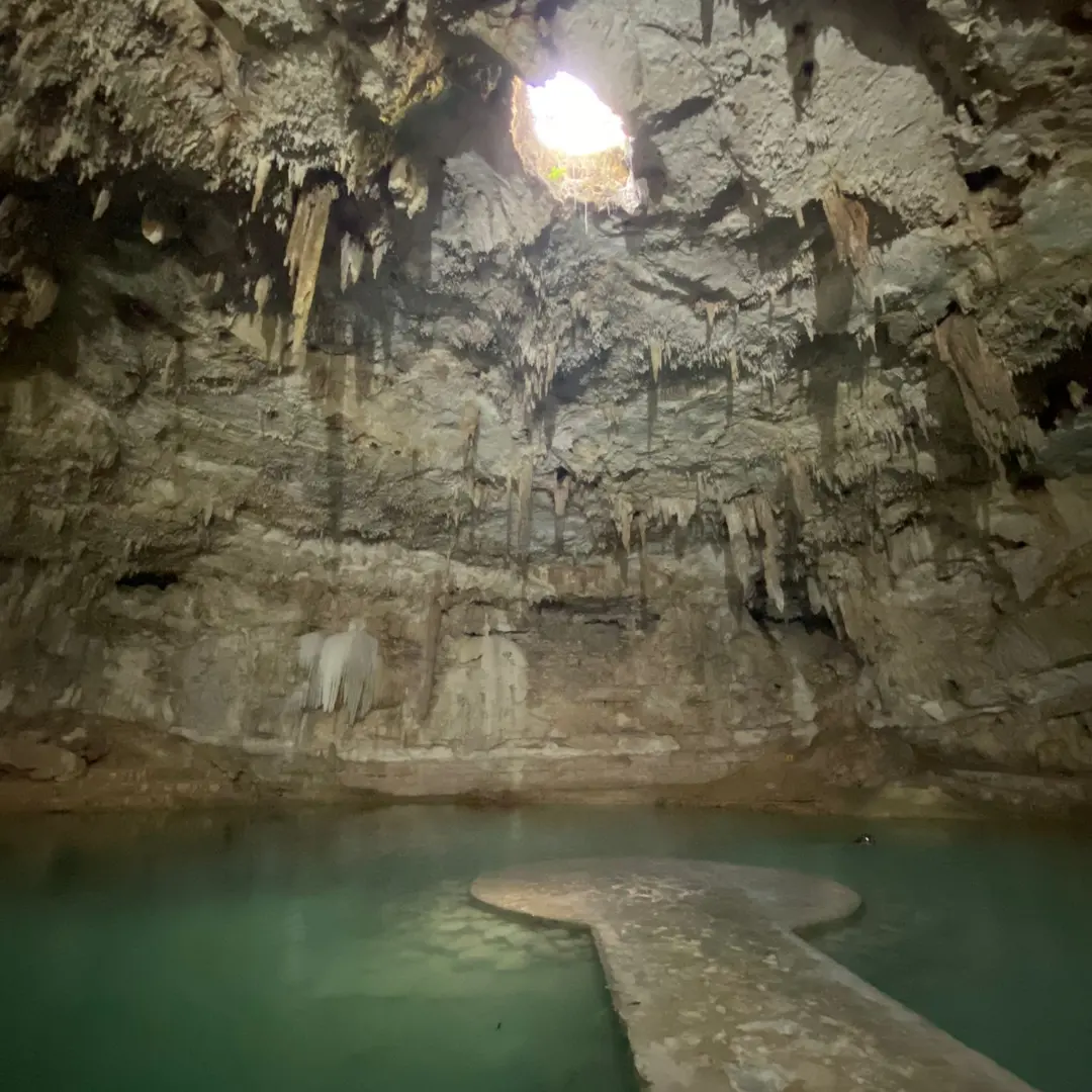 Stone platform and light inside Cenote Suytun